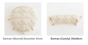 Detail of bohemian cream knit cushions with tufted patterns and tassel accents