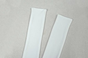 Detail of white stretch fabric sleeves with seamless edges on a grey background