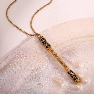 Detail of 18K gold plated Monkey King staff pendant with cloud patterns and engraving
