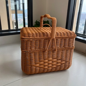 Detail of woven rattan picnic basket featuring reinforced handle and secure lid closure