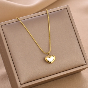 French style gold heart necklace with white shell inlay on a jewelry display box