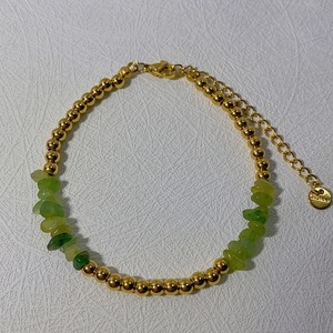 Detail view of gold stainless steel bead bracelet with green natural stones and clasp