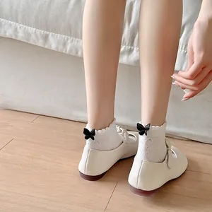 White cotton JK socks with ruffled lace edges and black bow knots for women