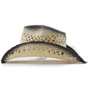 Detail of western straw cowboy hat featuring breathable hollow holes and black gradient brim