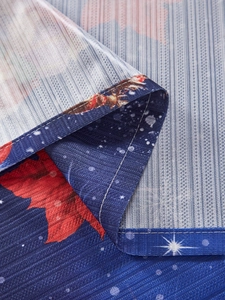 Close-up of stitched edge on Christmas theme tablecloth with snowflake pattern