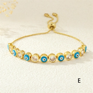 Adjustable golden evil eye bracelet with blue enamel and cubic zirconia stones