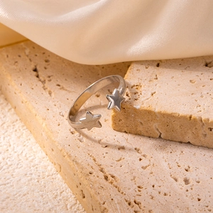 Close-up of adjustable stainless steel ring featuring dual five-pointed star design
