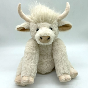 Detailed close-up of a plush Highland Cow toy with cream faux fur and curved horns