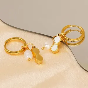 Gold stainless steel hoop earrings featuring irregular pearls and figure-eight shell charms