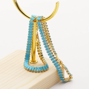 18K gold plated bracelet featuring rectangular blue turquoise stones on a gold metal stand