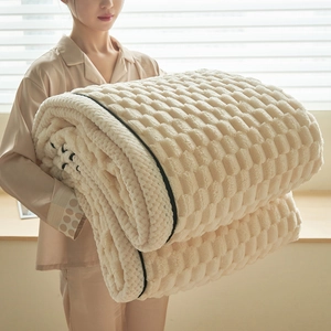 Thick cream waffle textured flannel blanket shown in a cozy home setting for warmth