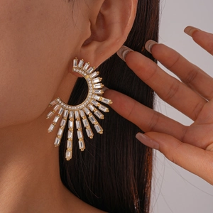 Luxe geometric gold fan-shaped earrings with sparkling cubic zirconia on model