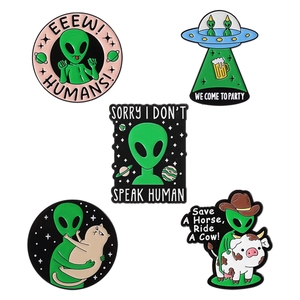 Cartoon alien and UFO enamel pin set with creative ET designs on white background