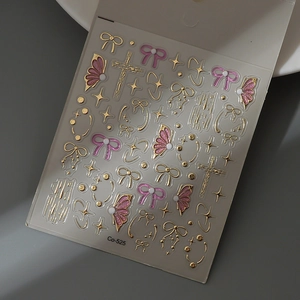 Macro shot of Co-525 3D pink and gold embossed bow, star, and butterfly nail stickers
