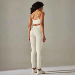 Close-up of seamless ribbed knit texture on back of beige sports bra and high-waist leggings