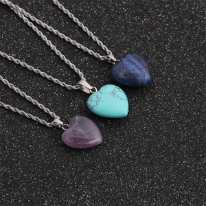 Detailed view of heart-shaped stone pendants in blue, turquoise, and purple on silver chains