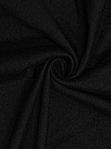 Macro-weergave van de hoogwaardige zwarte getextureerde stof met elegante spiraalplooien