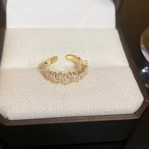 Detail of a gold multi-layer ring with sparkling zircon and pearl on a jewelry box pad