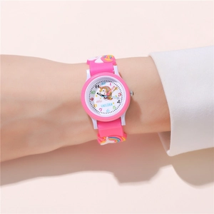 Pink silicone kids watch with unicorn embossed strap and colorful dial on a wrist