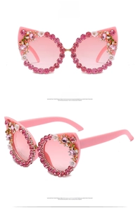 Detailed views of pink cat-eye sunglasses with rhinestone edges and floral decorations