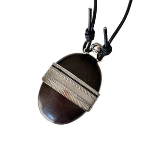 Ethnic wood and leather pendant necklace with silver metal accents on black braided cord