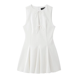 Detail of white sleeveless mini dress with cutout neckline and delicate bow accents