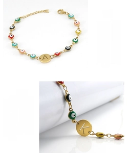 Detail view of gold stainless steel Evil Eye bracelet with personalized letter charms