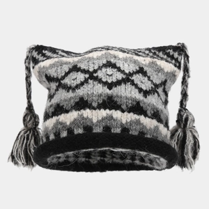 Detail of Fair Isle knit cat ear beanie featuring geometric jacquard and tassel braids