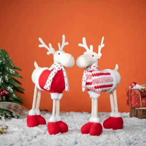 Plush Christmas reindeer decor pair in festive red sweaters and scarves on snow