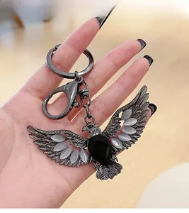 Detail showing vintage eagle keychain with cat eye stones and antique silver finish