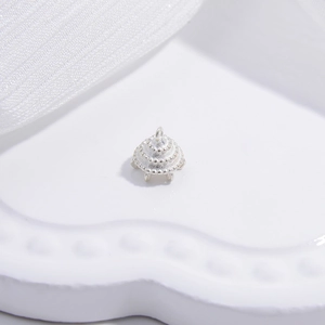 Macro detail of S925 sterling silver crown floral bead cap with embossed dot patterns