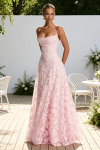 Close-up of pink floor-length dress with intricate floral texture and thin straps