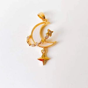 Macro detail of 18k gold moon and star pendant with white shell and inlaid zirconia