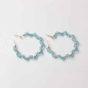 Elegant gold hoop earrings with light blue crystal stones for a minimalist trendy look