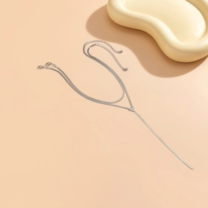 Detail of minimalist silver multi-layer snake bone Y-necklace with triangular metal pendant