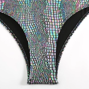 Detail of holographic laser fabric with crocodile scale texture on sexy bikini bottom