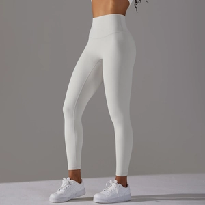 Detail view of white high-waisted yoga leggings showing elastic fabric and premium fit