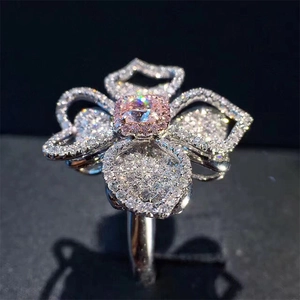 Luxury flower ring with pink cushion cut center stone and pavé diamond petals