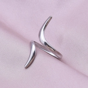 Detail of minimalist 304 stainless steel geometric ring on pink satin fabric background