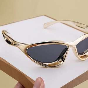Detailed 45-degree angle of shiny gold sports sunglasses frame and dark grey lenses