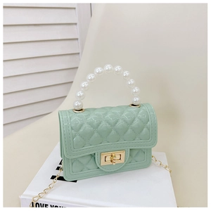 Detail of mint green jelly handbag with diamond lattice pattern and pearl handle strap