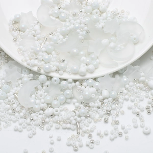 Macro view of white, silver, and frosted moon and star beads for DIY jewelry making
