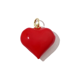 Close-up of a 3D red heart charm with gold ring for DIY jewelry necklace making