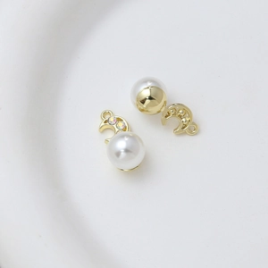 Detail view of golden moon pendant with white pearl and sparkling zircon rhinestones