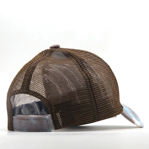 Detail of adjustable velcro strap and breathable mesh back on tie-dye trucker hat