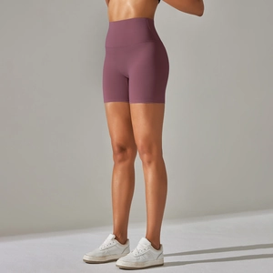 Macro detail of high-waisted seamless yoga shorts in breathable dark purple fabric