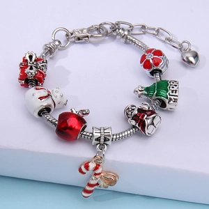 Christmas charm bracelet with snowman, Santa, and candy cane pendants on silver snake chain