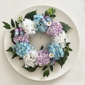 Detail of autumn wreath featuring blue and purple hydrangeas with decorative butterflies