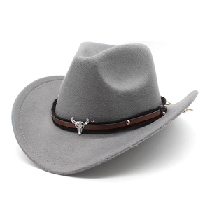 Detail of grey wool felt cowboy hat featuring brown leather band and silver bull head icon