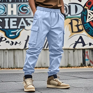 Close-up of men's loose light blue cargo pants featuring large side pockets and drawstring